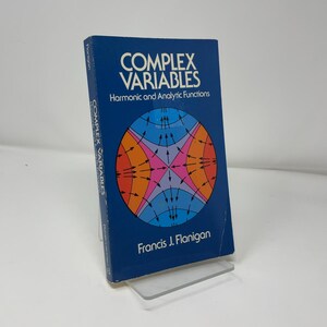 May include: A blue book titled "Complex Variables" with the subtitle "Harmonic and Analytic Functions." The cover features a colorful geometric design. The author's name, Francis J. Flanigan, is printed at the bottom.