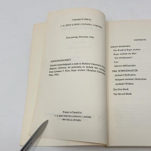 May include: A book titled "The Scholemaster" by Roger Ascham. The book cover features the title in black text on a white background. The book is a classic work of education and literature.