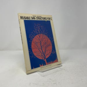 May include: A softcover book titled Reusable Data Structures for C by Roger Sessions. The cover features a cream background with a large blue rectangular graphic containing a red circular sun and a black silhouette of a leafless tree.