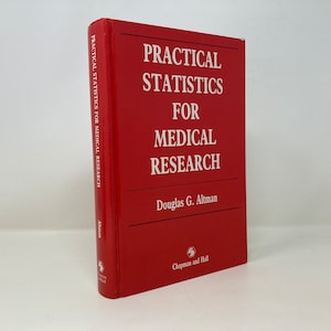 May include: A red hardcover book titled "Practical Statistics for Medical Research" by Douglas G. Altman. The book is published by Chapman and Hall.