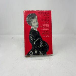 May include: A vintage hardcover book titled "The Whole Truth and Nothing But" by Hedda Hopper. The book has a red cover with white text and a black and white image of Hedda Hopper. The book is a biography.