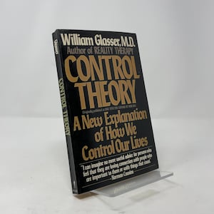 May include: A hardcover book titled "CONTROL THEORY" by William Glasser, M.D. The book has a black cover with gold lettering and the subtitle "A New Explanation of How We Control Our Lives."