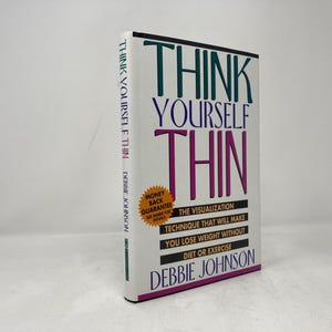 May include: A hardcover book titled "THINK YOURSELF THIN" by Debbie Johnson. The book has a white cover with the title in large, colorful letters. It promises weight loss through visualization, without diet or exercise.