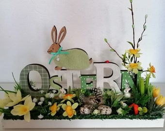 Spring arrangement, Easter arrangement with rabbits and spring flowers on a wooden tray