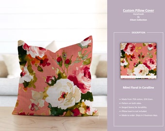 May include: A coral pink pillow cover with a floral pattern featuring white, pink, and red roses. The pillow cover is made from 75% cotton and 25% linen. The text "Mimi Floral in Coralline" is visible in the image.