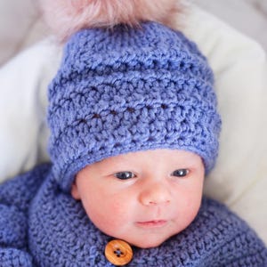 Close-up of textured crochet beanie stitches worn on baby