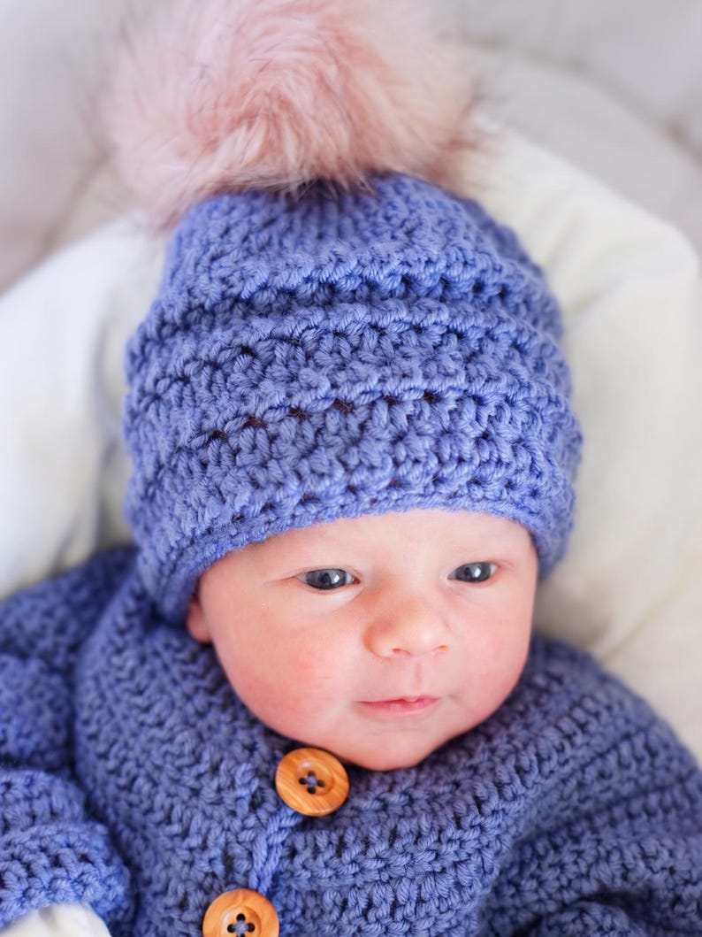 Close-up of textured crochet beanie stitches worn on baby