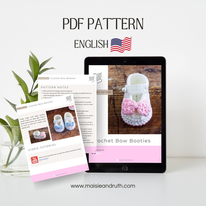 May include: A digital PDF pattern for crocheting baby booties with a bow. The pattern is in English and includes a video tutorial. The booties are white with a pink bow and are shown on a tablet.