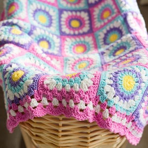 Close-up of sunburst granny square stitches in a crochet baby blanket