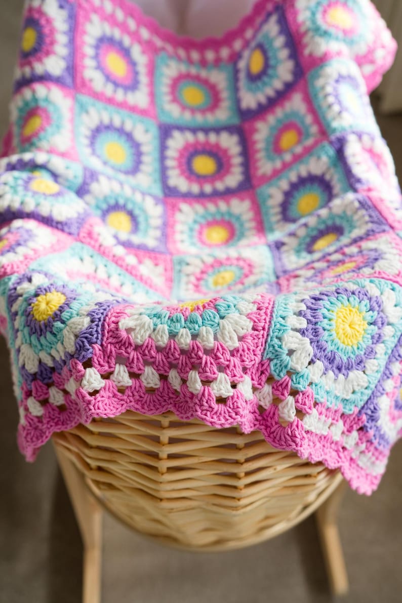 Close-up of sunburst granny square stitches in a crochet baby blanket