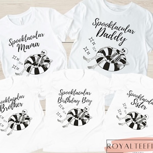 May include: White t-shirts with black text and graphics. Each shirt has the word "Spooktacular" followed by "Mama", "Daddy", "Brother", "Birthday Boy", or "Sister". Each shirt features a skeleton in a black and white inner tube.