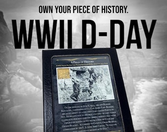 May include: A framed piece of history commemorating WWII D-Day. The black frame holds a detailed image and text about the 2nd Ranger Battalion's mission at Pointe du Hoc. The text includes the phrase "Own Your Piece of History."