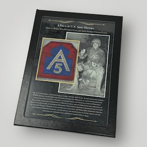 May include: A framed display featuring a vintage World War II United States 5th Army soldier uniform patch. The patch is red, blue, and white with a stylized "A" and "5" in the center. The display also includes a black and white photograph of a soldier in uniform.