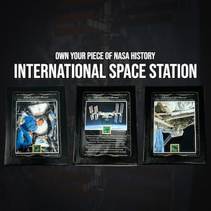 May include: Three black framed plaques with a white background and a picture of the International Space Station. The plaques have the text "A Piece of NASA History" and "International Space Station" printed on them.