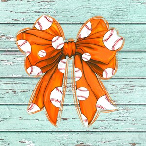 May include: Orange bow with white baseballs printed on it. The bow is against a light blue wooden background.