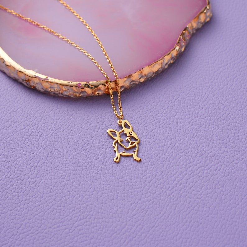 a close up of frenchie french bulldog british bulldog necklace with its 14k solid gold chain in picture