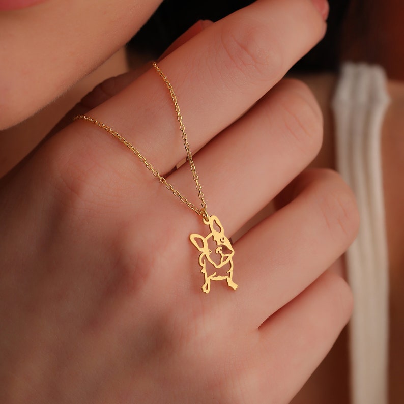 woman has her french bulldog gift for her on her hands frenchie pendant looks dainty and minimalist