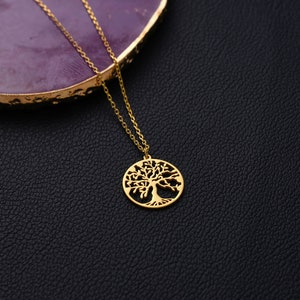 close up of gold plated tree of life necklace charm with 14k solid gold chain