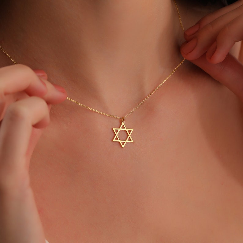 May include: A gold chain necklace with a Star of David pendant.