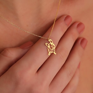 woman touching the gold plated french bulldog frenchie necklace