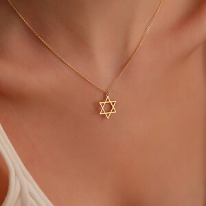 May include: A gold chain necklace with a star of David pendant.