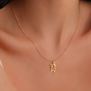 woman wearing french bulldog necklace with chains made of 14k solid gold