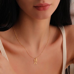 woman wearing gold plated frenchie dog memorial necklace