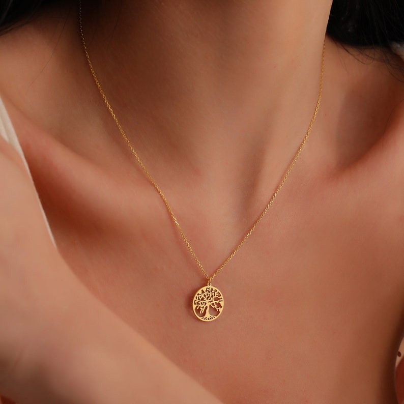 woman wearing 14k solid gold tree of life necklace