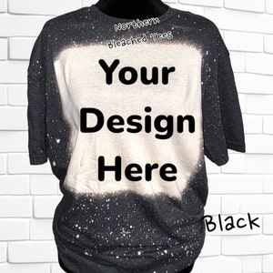 May include: Black bleached t-shirt with a white bleached area in the center. The text "Your Design Here" is printed in black on the white bleached area. The text "Northern Bleached Tees" is printed in black at the top of the shirt. The text "Black" is printed in black at the bottom of the shirt.