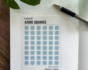 May include: A sheet of stickers with 49 light blue squares arranged in a grid. The sticker sheet is labeled "AZURE SQUARES" and "essentials" at the top and "dainty favors" at the bottom. The sticker sheet is made in the US.