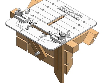 May include: A white jig with the text "ULM-IG" and "PRECISION ROUTER JIG SYSTEM" printed on it. The jig is mounted on a wooden base with two adjustable clamps. The jig has a variety of holes and slots for routing different shapes.