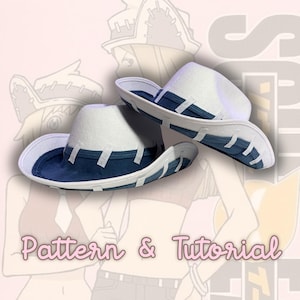 May include: Two white and dark blue hats with a wide brim and a structured crown. The hats feature a dark blue band around the base and white rectangular accents along the brim edge. The text Pattern & Tutorial is visible in pink.