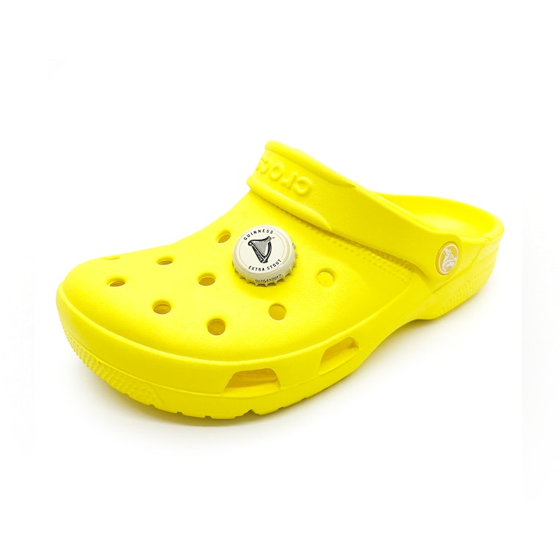 May include: A yellow pair of clogs with a Guinness Extra Stout bottle cap charm.