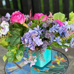 Floral Centerpiece: Lilac Hydrangeas, Pink Roses, Blue Glass Vase