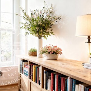 May include: An interior scene with a wooden bookshelf and a long wooden table. The table has a lamp, books, and potted plants. A vase of flowers and a decorative bowl with flowers are also present. A window and a chair are visible in the background.