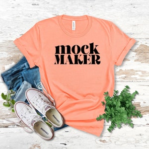May include: A peach coloured t-shirt with the text "mock maker" in black lettering.