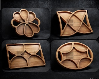 May include: Four wooden serving trays with different geometric designs. The trays are made of light brown wood and have a natural finish. The designs are intricate and include circles, squares, and triangles.