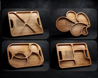 May include: Four wooden serving trays with different shapes and compartment configurations. The trays are made of light brown wood and have a natural finish.
