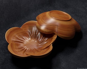 May include: Two wooden bowls in the shape of a flower. The bowls are made of light brown wood and have a natural wood grain. The bowls are stacked on top of each other.