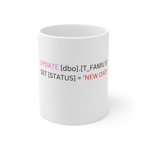 May include: White ceramic mug with the text "UPDATE [dbo].[T_FAMILY SET [STATUS] = 'NEW DAD'" printed in pink and red.