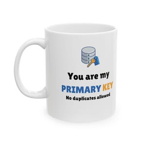 May include: White ceramic mug with a blue and orange design. The mug features a database icon and the text "You are my PRIMARY KEY No duplicates allowed".
