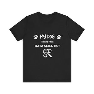May include: Black t-shirt with white text that reads "My Dog thinks I'm a Data Scientist" with a paw print on either side of the text and a magnifying glass with binary code inside.