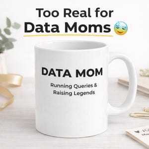 May include: A white ceramic mug with a black handle and the text "But First, Coffee" in a bold, black font. The mug is set against a blurred background, suggesting a cosy setting.