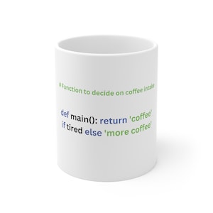 May include: White ceramic mug with green and blue text that reads: "#Function to decide on coffee intake def main(): return 'coffee' if tired else 'more coffee'"