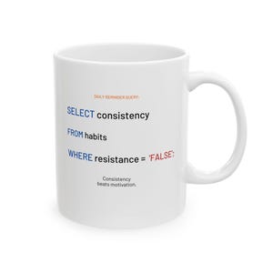 May include: White ceramic mug with a curved handle. The mug features the text "DAILY REMINDER QUERY: SELECT consistency FROM habits WHERE resistance = 'FALSE'; Consistency beats motivation." in blue, red, and black font.