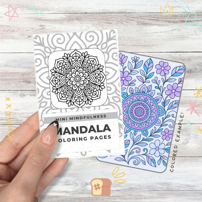 May include: A hand holding a set of mini mandala coloring pages. One page features a black and white mandala design, while the other is a colored example with a floral and mandala pattern. The text reads "Mini Mindfulness Mandala Coloring Pages."