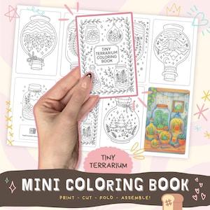 May include: A mini coloring book with the title "Tiny Terrarium Coloring Book" is held in front of a sheet of terrarium illustrations. The illustrations are in black and white, featuring various terrarium designs. The bottom of the image reads "Mini Coloring Book" and "Print - Cut - Fold - Assemble!"