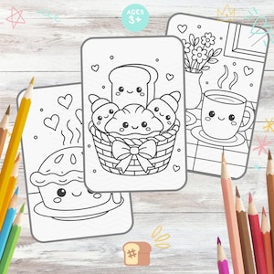 May include: Three coloring pages with food-themed illustrations and the text "AGES 3+". One page features a pie, another a basket of croissants and bread, and the last a cup of coffee and flowers. Colored pencils are scattered around the pages.