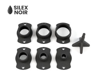 May include: A set of six black plastic rings with a center hole and two small holes on each side. There is also a black plastic star-shaped piece with a center point.