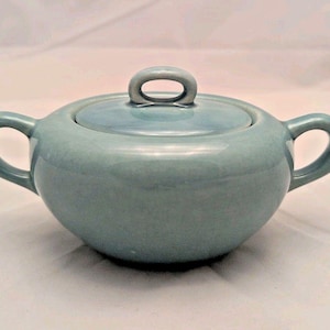 May include: A set of three ceramic mugs with a speckled, matte finish. The mugs are in shades of cream, light gray, and dark gray. Each mug has a simple, minimalist design, perfect for coffee or tea.